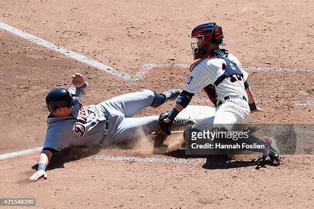 James McCann of the Detroit Tigers is out as Chris Herrmann of the Minnesota Twins defends home plate during the fifth inning of the game on April...