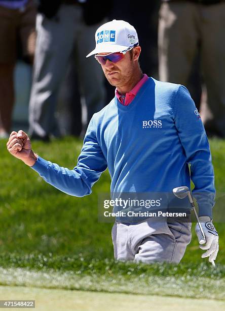 Mikko Ilonen of Finland reacts after chipping in from the bunker on the ninth hole during round one of the World Golf Championship Cadillac Match...