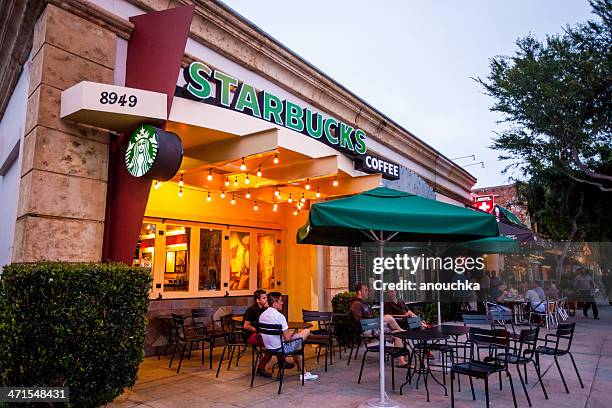 people sitting at starbucks coffee in west hollywood, usa - starbucks stock pictures, royalty-free photos & images
