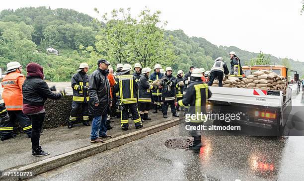 flood in burghausen june 2013 - firefighters in the shower stock pictures, royalty-free photos & images