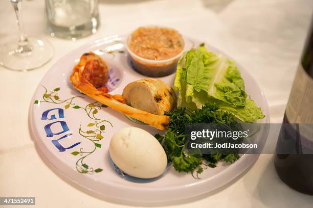 traditional passover seder table with haggadah - passover seder plate stock pictures, royalty-free photos & images