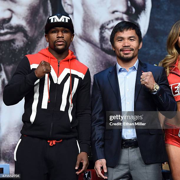Welterweight champion Floyd Mayweather Jr. And WBO welterweight champion Manny Pacquiao pose during a news conference at the KA Theatre at MGM Grand...