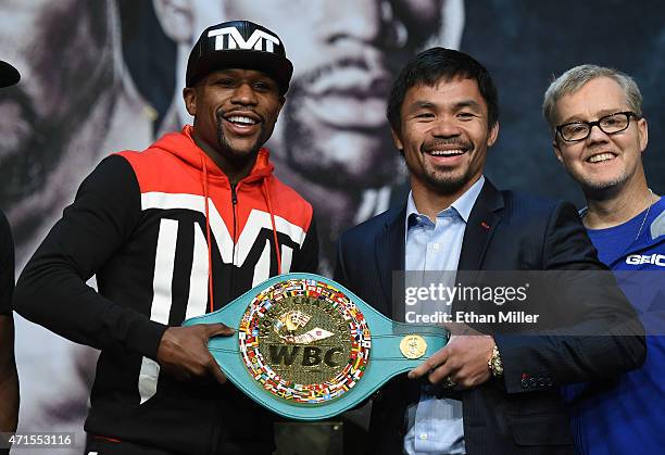 Welterweight champion Floyd Mayweather Jr. And WBO welterweight champion Manny Pacquiao pose with a WBC championship belt as Pacquiao's trainer...