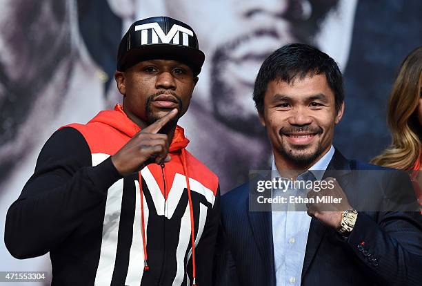 Welterweight champion Floyd Mayweather Jr. And WBO welterweight champion Manny Pacquiao pose during a news conference at the KA Theatre at MGM Grand...