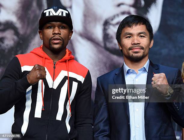 Welterweight champion Floyd Mayweather Jr. And WBO welterweight champion Manny Pacquiao pose during a news conference at the KA Theatre at MGM Grand...