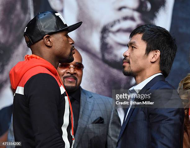 Welterweight champion Floyd Mayweather Jr. And WBO welterweight champion Manny Pacquiao face off during a news conference at the KA Theatre at MGM...
