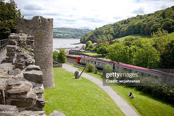 virgin voyager train passes conwy castle - now voyager stock pictures, royalty-free photos & images