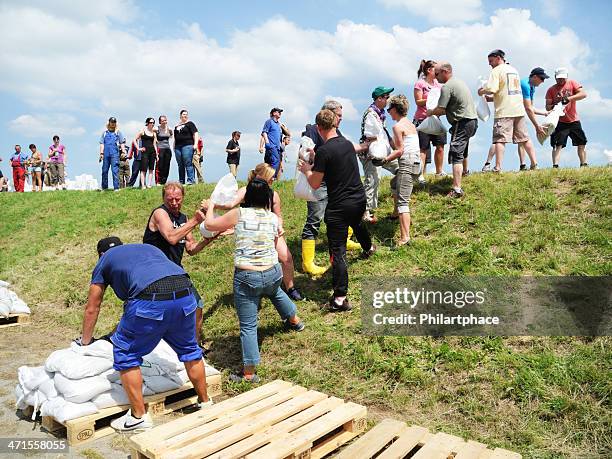 people fighting flood water - sandbag stock pictures, royalty-free photos & images