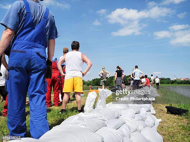 menschen kämpfen flut wasser - sandbag stock-fotos und bilder