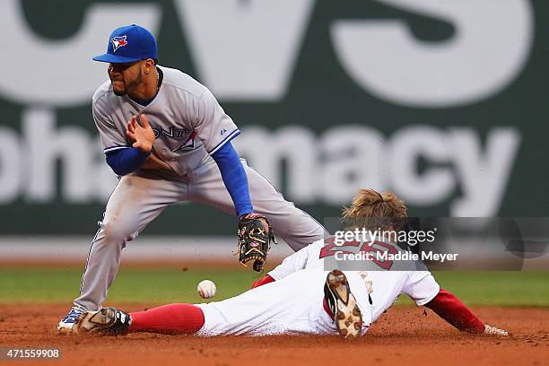 Brock Holt of the Boston Red Sox safely steals second, evading a tag from Devon Travis of the Toronto Blue Jays during the second inning at Fenway...