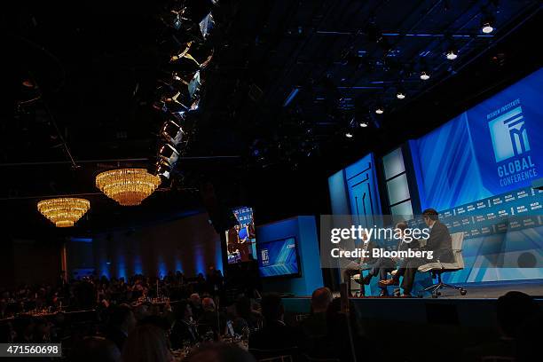 Jerry Brown, governor of California, left, speaks during the annual Milken Institute Global Conference in Beverly Hills, California, U.S., on...