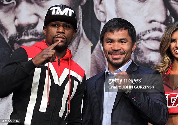 Welterweight champion Floyd Mayweather Jr. And WBO welterweight champion Manny Pacquiao pose during a news conference at the KA Theatre at MGM Grand...