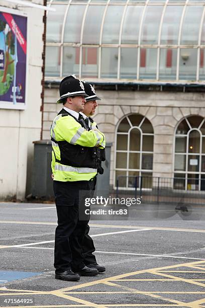 two policemen on duty at city centre music festival - south wales stock pictures, royalty-free photos & images