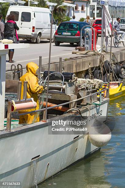 fisherman prepare the fishing net at port - cattolica beach stock pictures, royalty-free photos & images