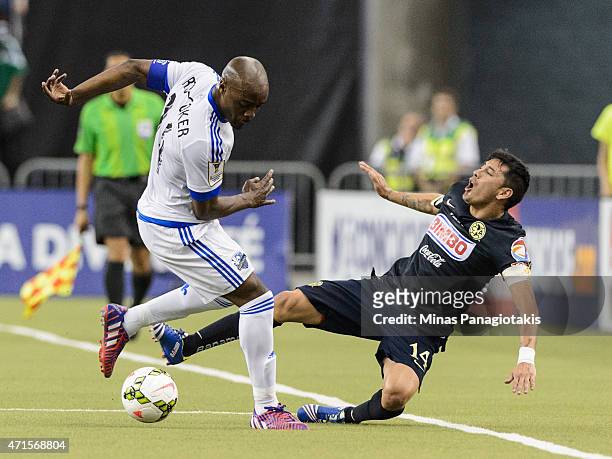 Nigel Reo-Coker of the Montreal Impact trips Rubens Sambueza of Club America in the 2nd Leg of the CONCACAF Champions League Final at Olympic Stadium...