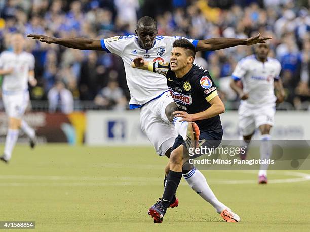 Bakary Soumare of the Montreal Impact fouls Oribe Peralta of Club America in the 2nd Leg of the CONCACAF Champions League Final at Olympic Stadium on...