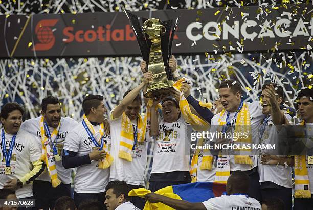 Club America players celebrate with the trophy after defeating the Montreal Impact in the CONCACAF Champions League return leg final 4-2, to win 5-3...