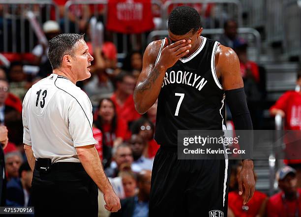 Joe Johnson of the Brooklyn Nets reacts as he walks to the bench past referee Monty McCutchen during Game Five of the Eastern Conference...