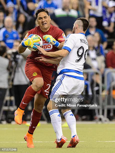Jack McInerney of the Montreal Impact runs into goalkeeper Moises Munoz of Club America after Munoz made a save in the 2nd Leg of the CONCACAF...