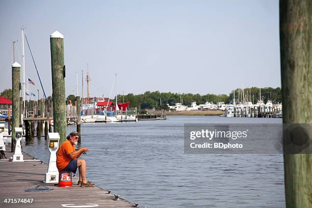 fishing off of a pier at lewes, delaware - lewes sussex stock pictures, royalty-free photos & images