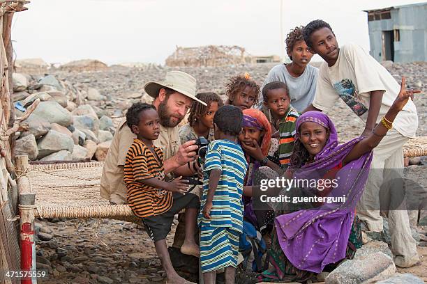 western tourist is showing camera images to ethiopian children - eritrean woman stock pictures, royalty-free photos & images