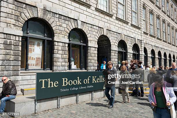 visiting the book of kells at trinity college in dublin, ireland - book of kells stock pictures, royalty-free photos & images