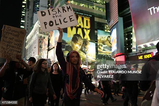 Demonstrators march through Times Square during a protest April 29, 2015 in New York, held in solidarity with demonstrators in Baltimore, Maryland...