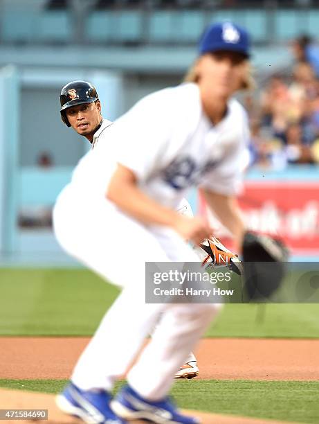 Nori Aoki of the San Francisco Giants runs to second base behind Zack Greinke of the Los Angeles Dodgers during the first inning at Dodger Stadium on...