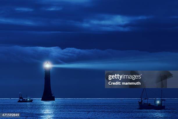 lighthouse and ships in the night - beacon stock pictures, royalty-free photos & images