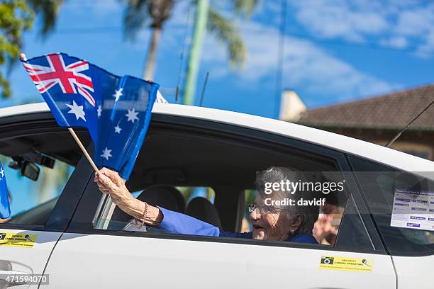 returned services veteran with australian flag at anzac day - australia day stock pictures, royalty-free photos & images