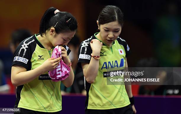 Fukuhara Ai and Wakamiya Misako of Japan react during their women's doubles quarter-final match match against Ding Ning and Li Xiaoxia of China at...