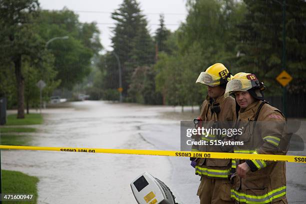 fire fighters prepare to search for flood victims - firefighters in the shower stock pictures, royalty-free photos & images