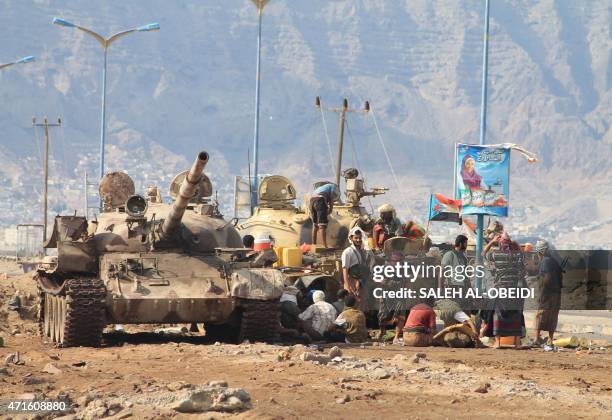 Loyalists of exiled Yemeni President Abedrabbo Mansour Hadi gather next to tanks on a road on the outskirts of the southern city of Aden, on April...