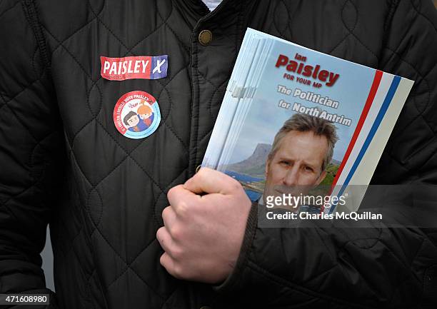 An election team member for Democratic Unionist Party Westminster candidate Ian Paisley Jr wears a sticker with the statement 'If I was 18 I would...