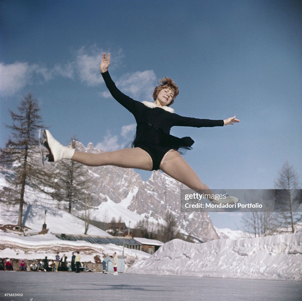 Figure skater performing a jump during 1956 Winter Olympics