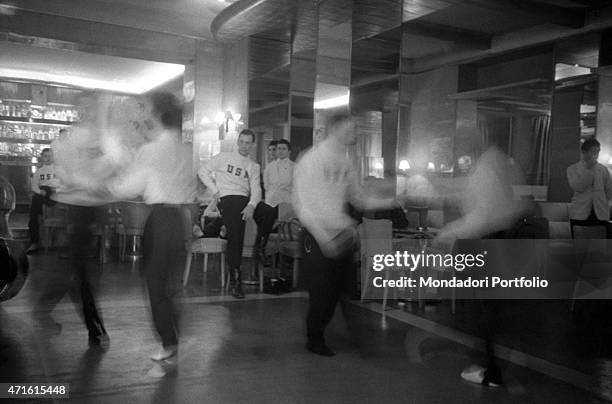 "Members of an American team competing in the VII Olympic Winter Games dancing during a break. Cortina d'Ampezzo, 1956 "
