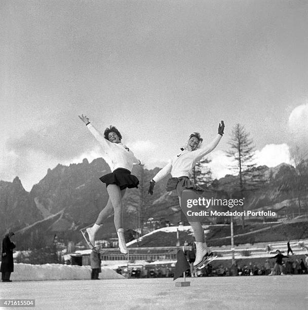 "Two figure skaters performing a figure during the VII Olympic Winter Games. Cortina d'Ampezzo, 1956 "