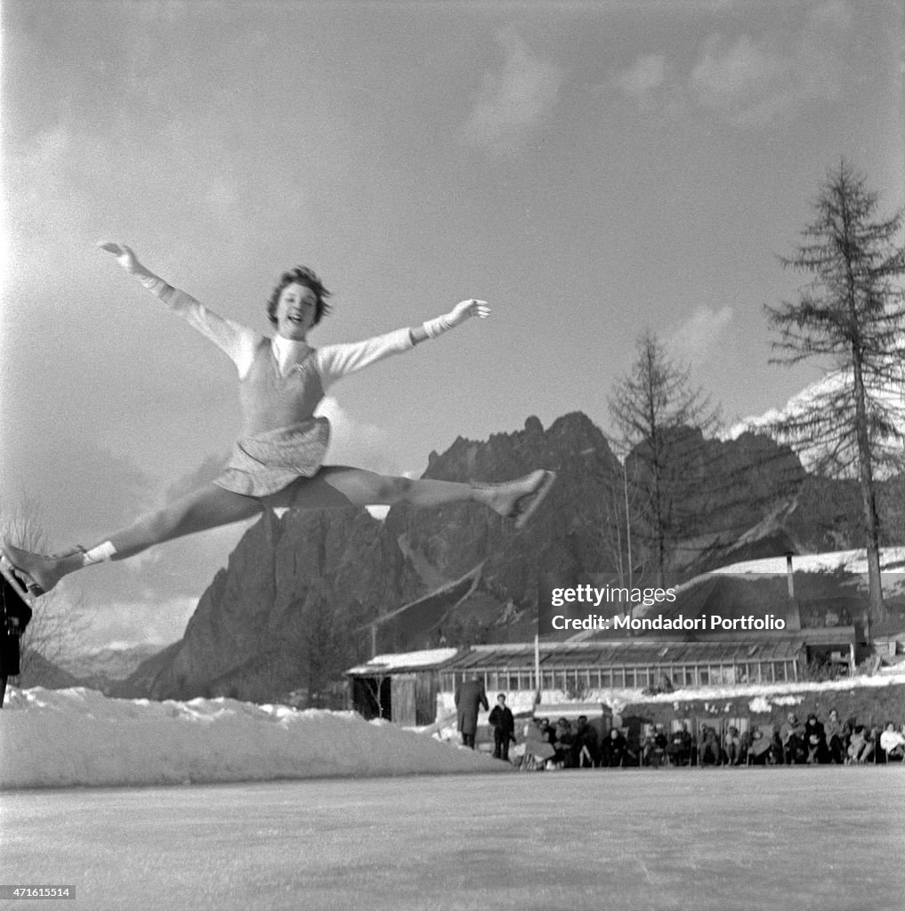 Figure skater performing a jump during 1956 Winter Olympics