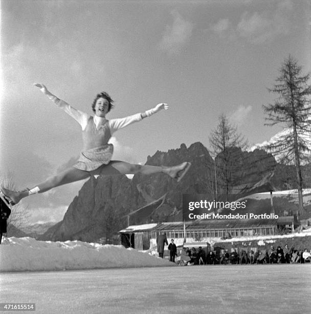 Figure skater performing a jump during the VII Olympic Winter Games. Cortina d'Ampezzo, 1956 "