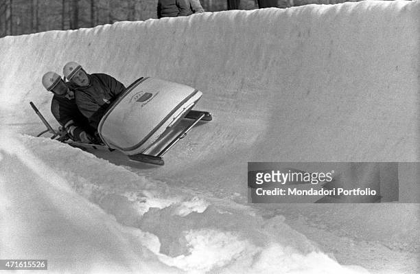 "Liechtensteiner bobsleigh team competing in a race at the VII Olympic Winter Games. Cortina d'Ampezzo, 1956 "