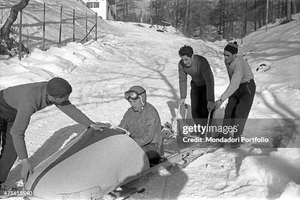 Bobsleigh team getting ready for a race at the VII Olympic Winter Games. Cortina d'Ampezzo, 1956 "