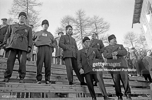 "Representatives of a British team in competition at the VII Olympic Winter Games watching a race. Cortina d'Ampezzo, 1956 "