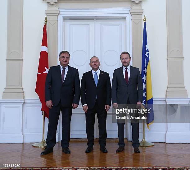 Chairman of Bosnia and Herzegovina's tripartite presidency, Mladen Ivanic , Turkish Foreign Minister Mevlut Cavusoglu shake hands with member of...