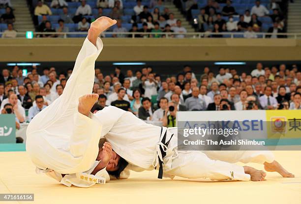 Ryu Shichinohe throws Kenta Nishigata to win by Ippon in the semi final of the All Japan Judo Championship at the Nippon Budokan on April 29, 2015 in...