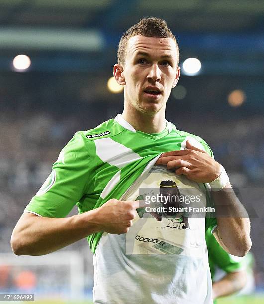 Ivan Perisic of Wolfsburg celebrates scoring the third goal by pointing to a picture of the late Junior Malanda of Wolfsburg who was killed in a car...