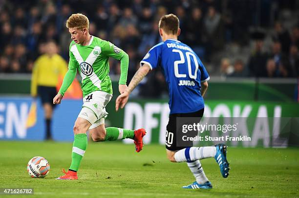 Kevin De Bruyne of Wolfsburg is challenged by Manuel Junglas of Bielefeld during the DFB Cup semi final match between Arminia Bielefeld and VfL...