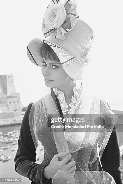 "Italian actress Sophia Loren as Cathrine Hubscher posing with Castel dell'Ovo in the background on the set of the film Madame. Naples, 1961 "