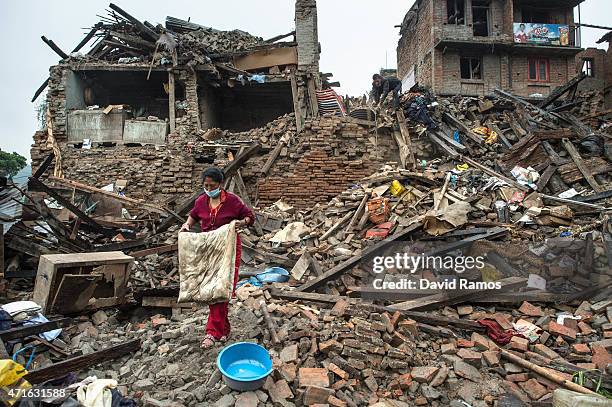 Nepalese victims of the earthquake search for belongings among debris of their collapsed home in Shankhu on April 30, 2015 in Kathmandu, Nepal. A...