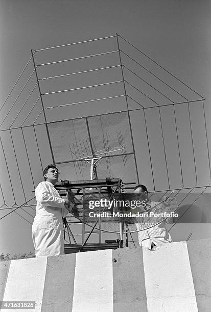 "Italian brothers and radio amateurs Achille and Giovanni Battista Judica Cordiglia settling an antenna to listen to Soviet and American astronauts'...