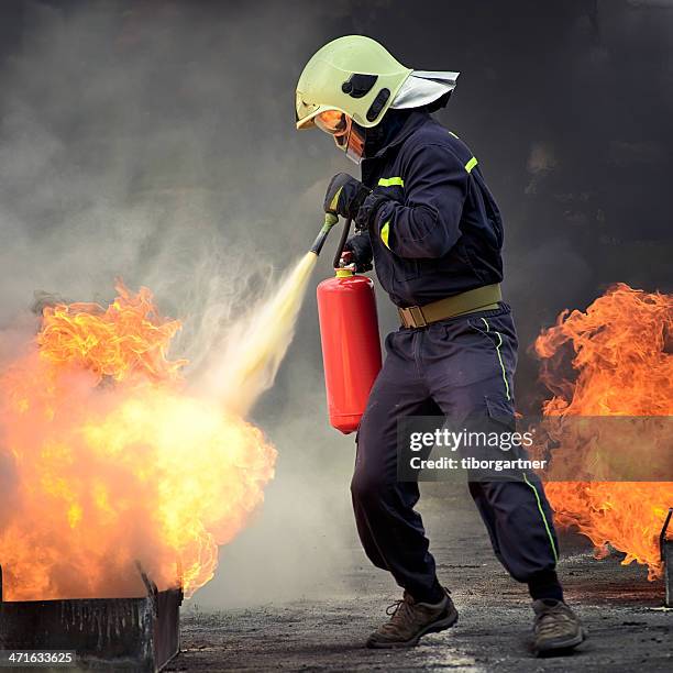 firefighter - extinguishing stock pictures, royalty-free photos & images